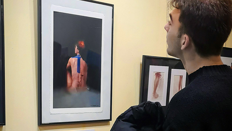 Visitants observant les obres de l’exposició “Moments” de Marta Serra Pou a la sala gran de la mostra.